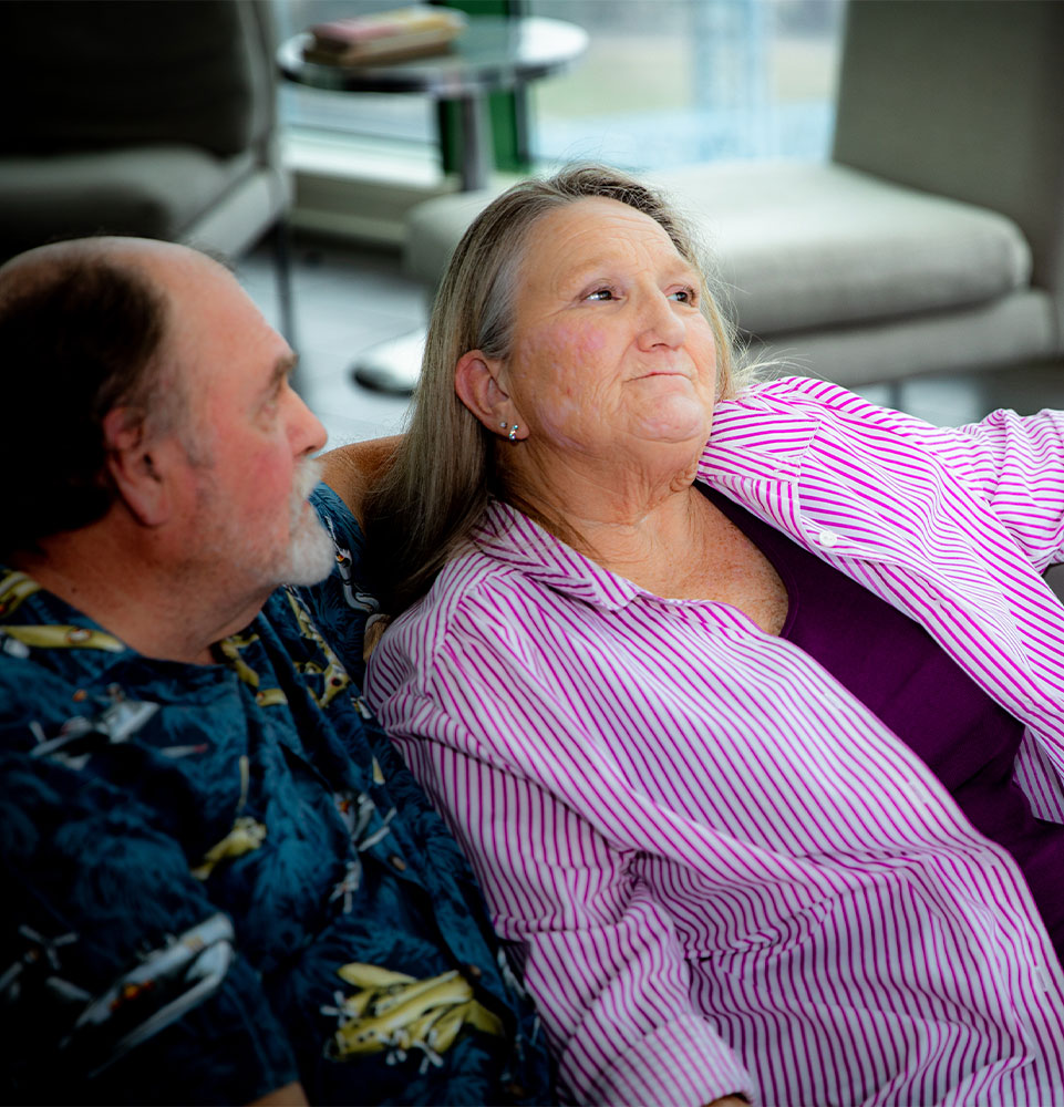 Patient sitting within dental office with implants