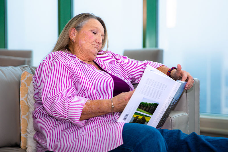 Female patient reading a book in the dental office