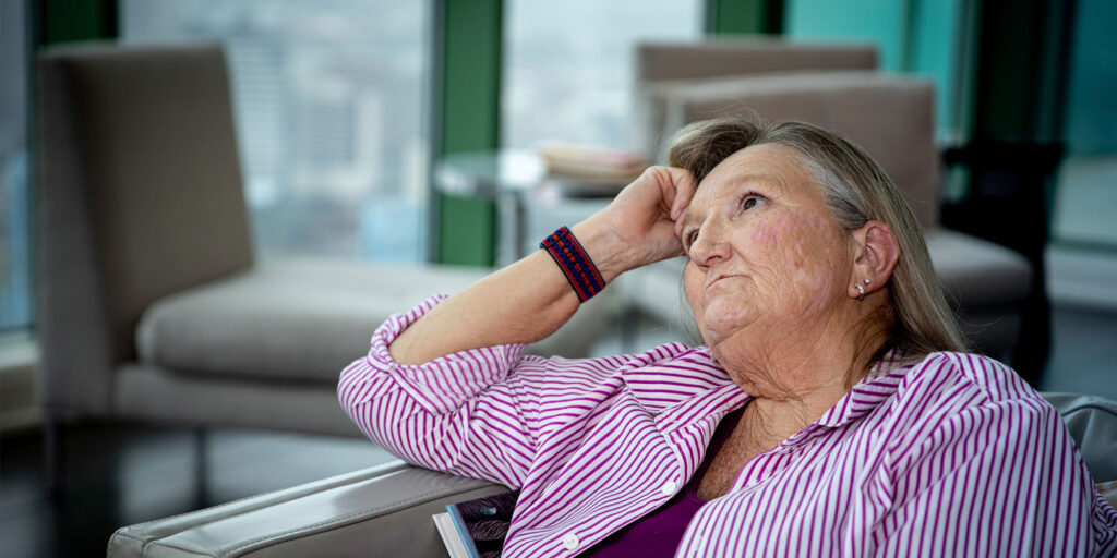 Older women patient sitting in dental office with implants