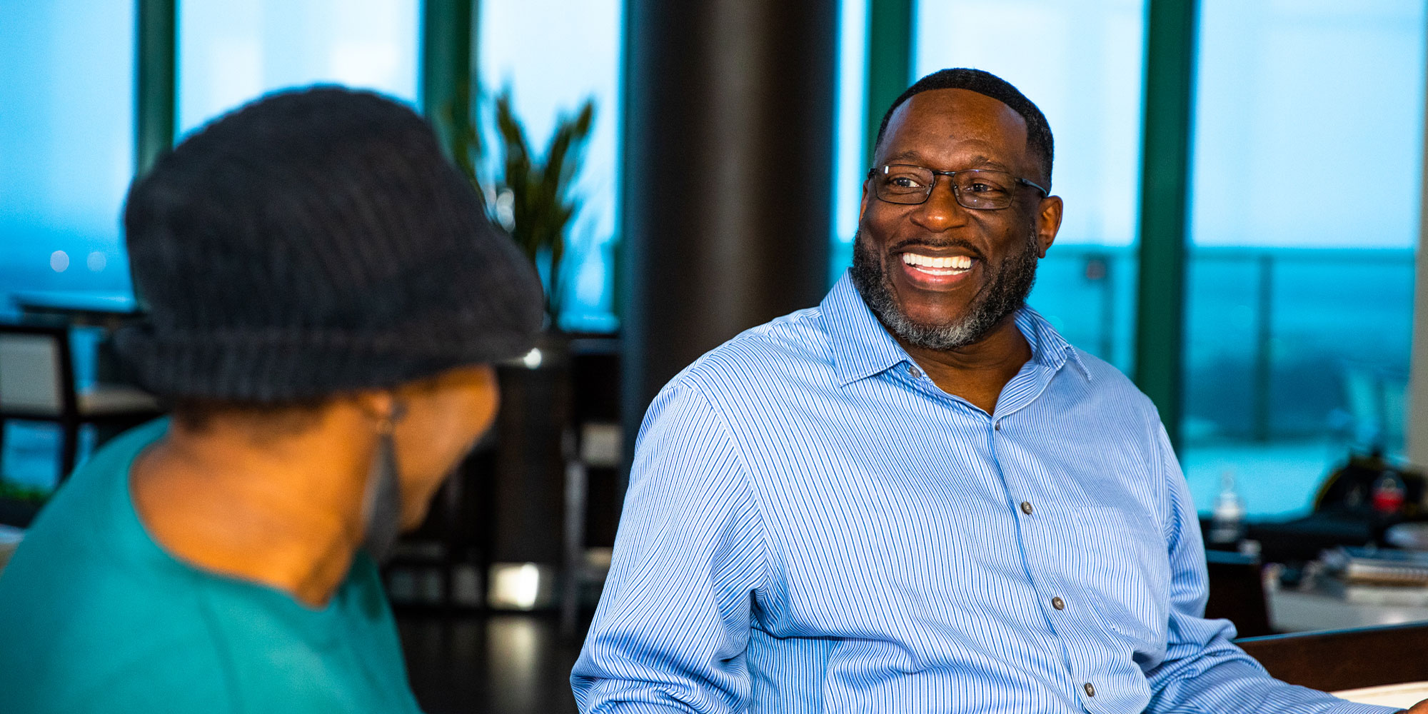 two patients smiling while having conversation