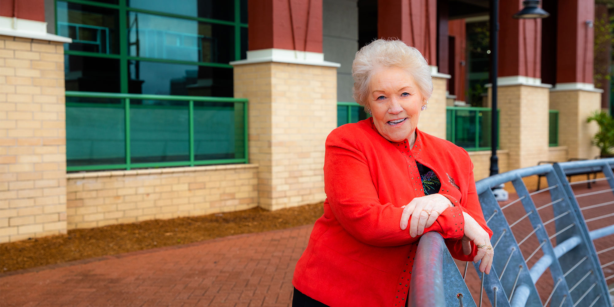 Older female patient by the bay enjoying and smiling with their new dental implants