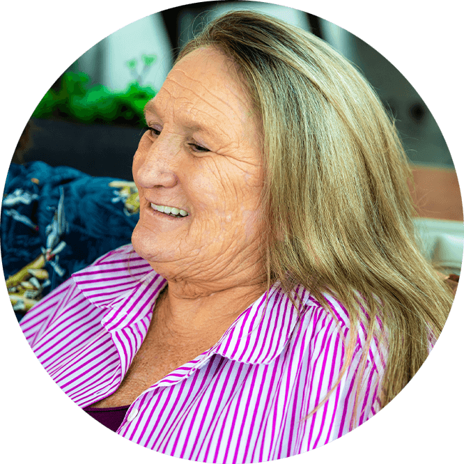 Female Patient smiling while having a conversation on the couch of the dental office