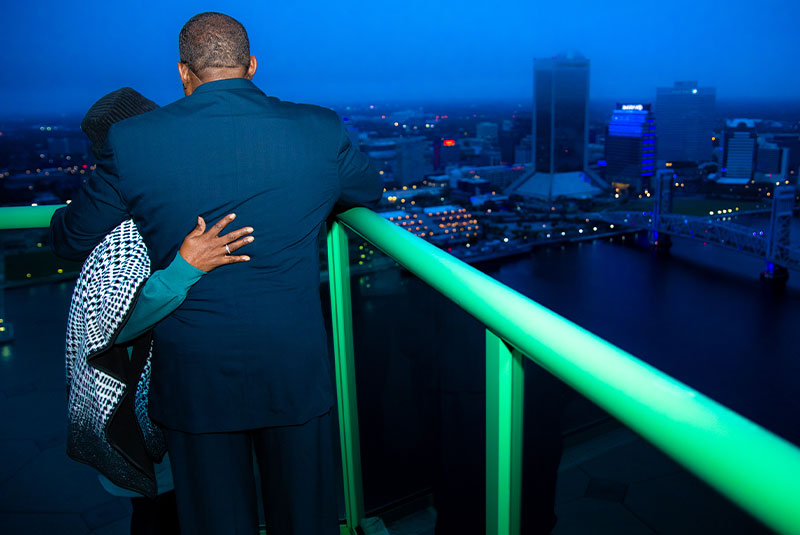 Patient and their partner looking out into the skyline of the city