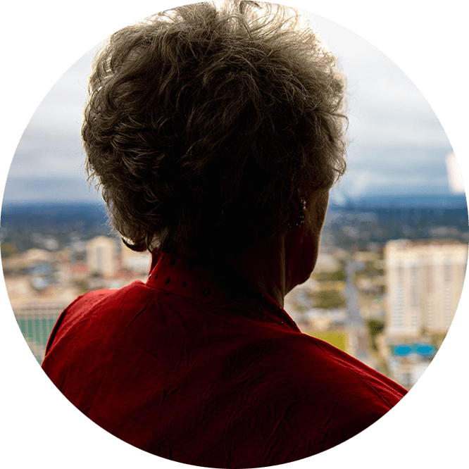 Older female patient looking out of the window enjoying their implant